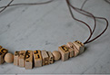 Jewellery in wood-letter
